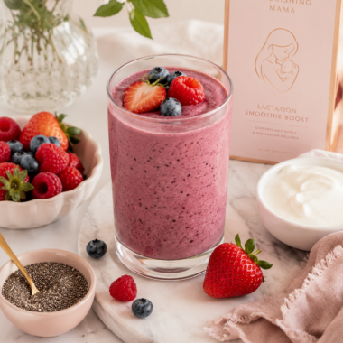 A berry smoothie topped with strawberry, raspberry and blueberries, with bowls of fresh berries, chia seeds and Greek yogurt